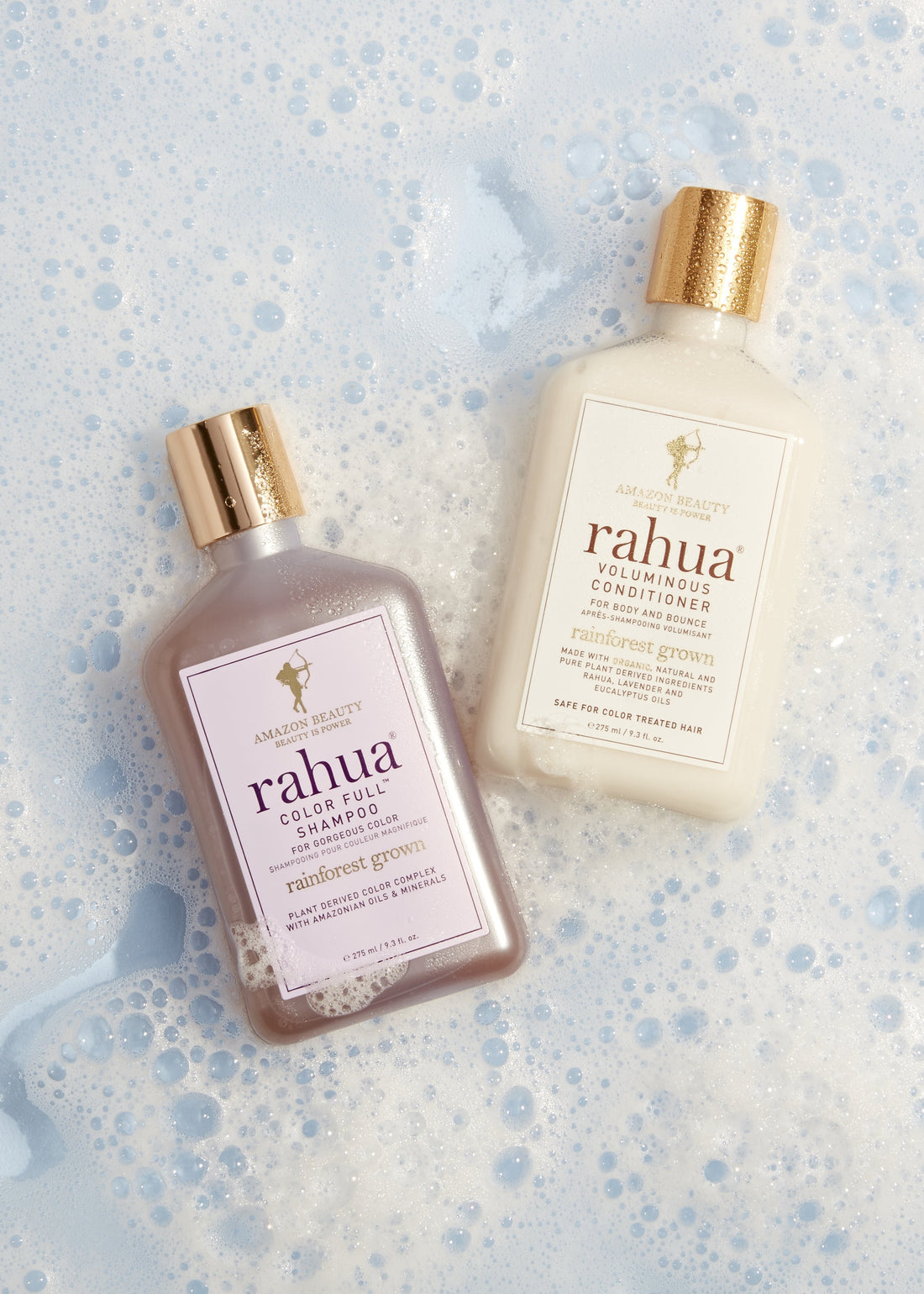 Rahua color full shampoo and voluminous conditioner on the floor with foam