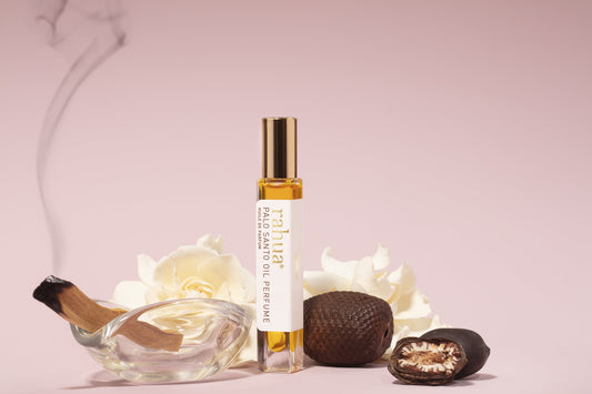 Rahua Palo santo oil perfume bottle with morete seeds, rahua seeds, gardenia flower and palo santo stick