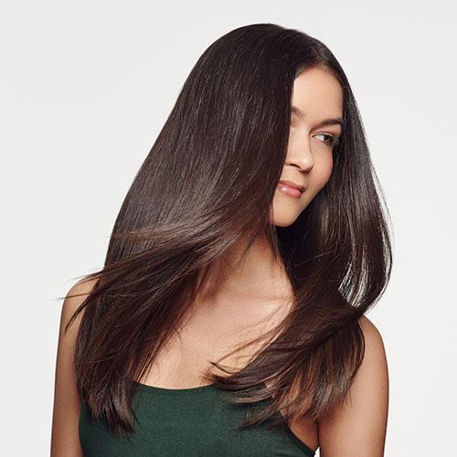 Women after using rahua products having silky and straight hairs