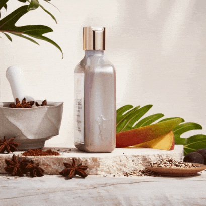 Rotating scalp exfoliating shampoo on a marble block with mango slice and star anise in herbal product equipment