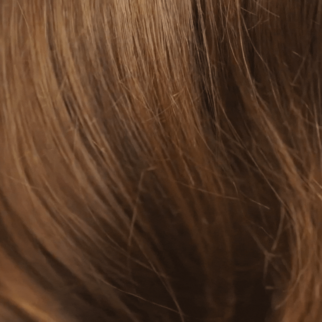Woman showing silky hair after using Rahua Heat Protectant Shield