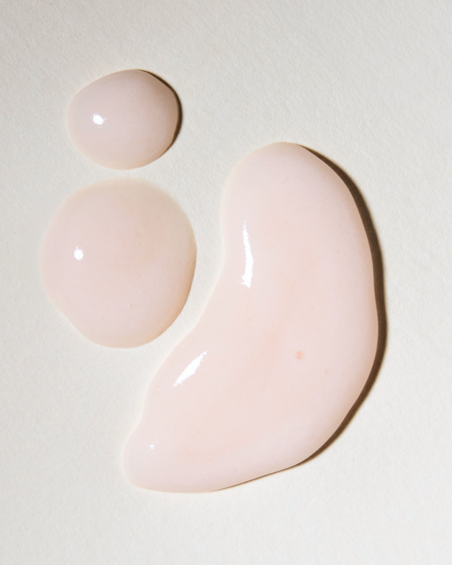 Three pink gel-like substances on a light beige background|variant:93-oz,18-oz