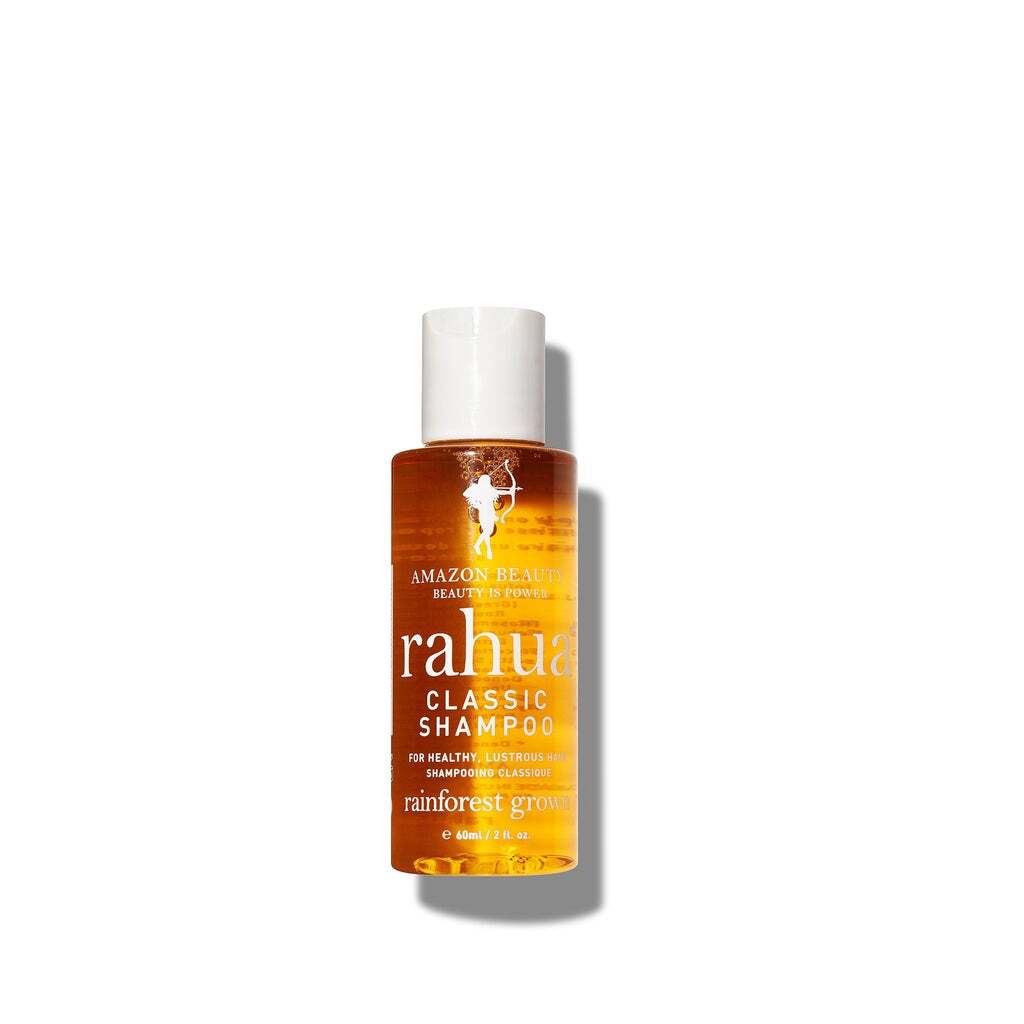 2 oz bottle of beige product with white label with brown lettering on a plain white background travel friendly travel sized tsa safe rahua classic shampoo|variant:2-oz