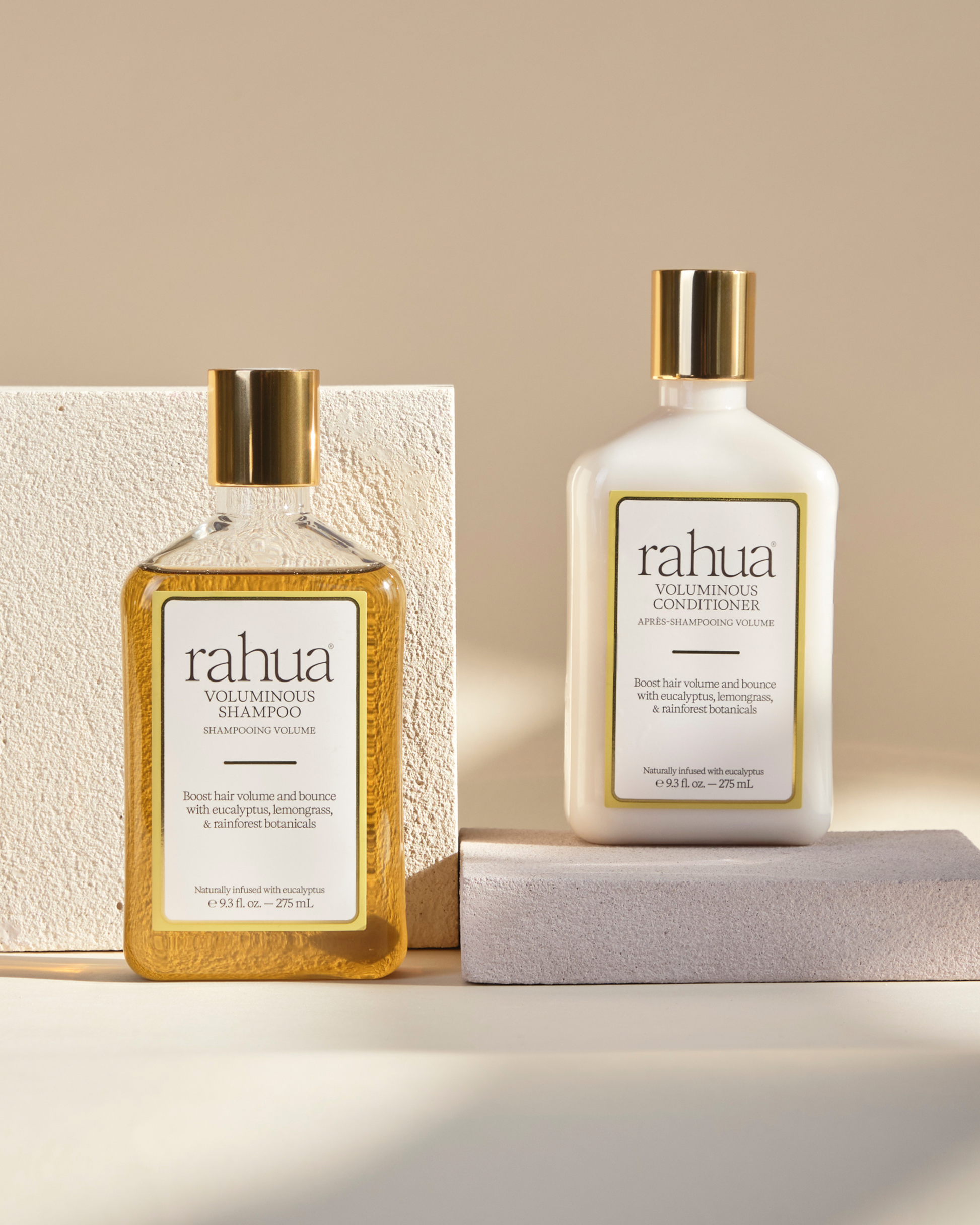 Two bottles of rahua hair care products on a neutral background|variant:93-oz
