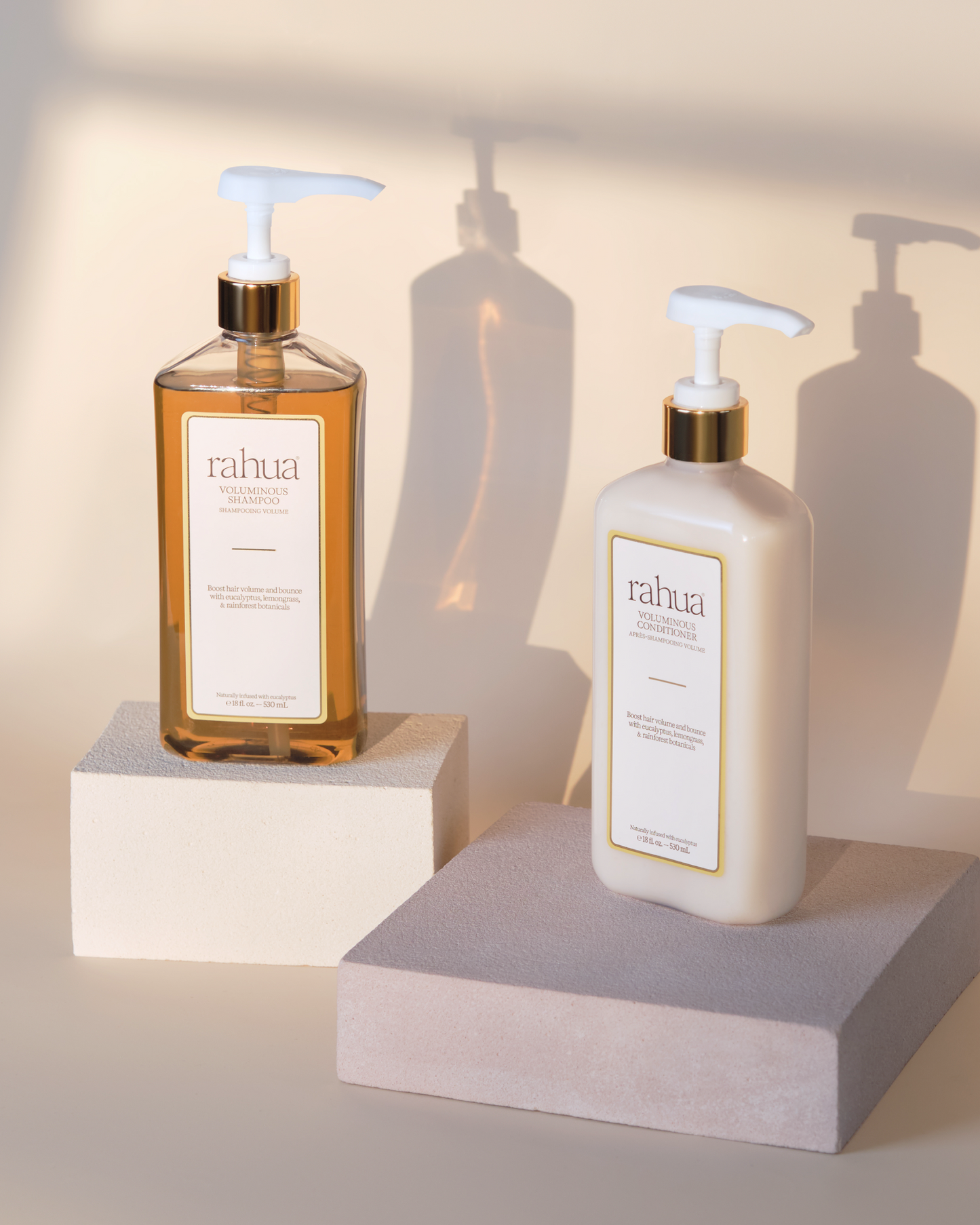 Two bottles of rahua products on a neutral background|variant:16-oz