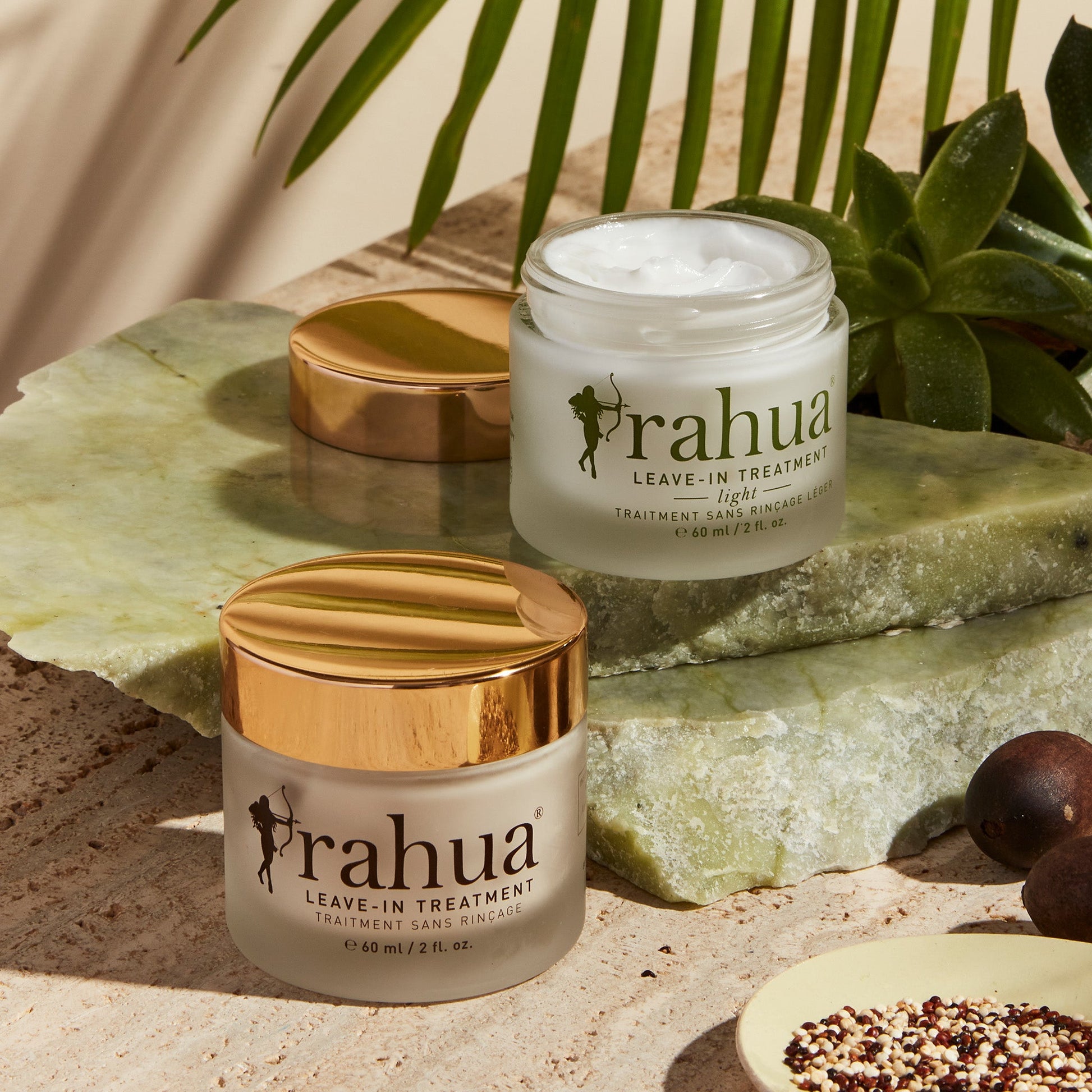 rahua leave in treatment and opened rahua leave in treatment light kept on a marble floor with rahua seeds and green leaves and plant