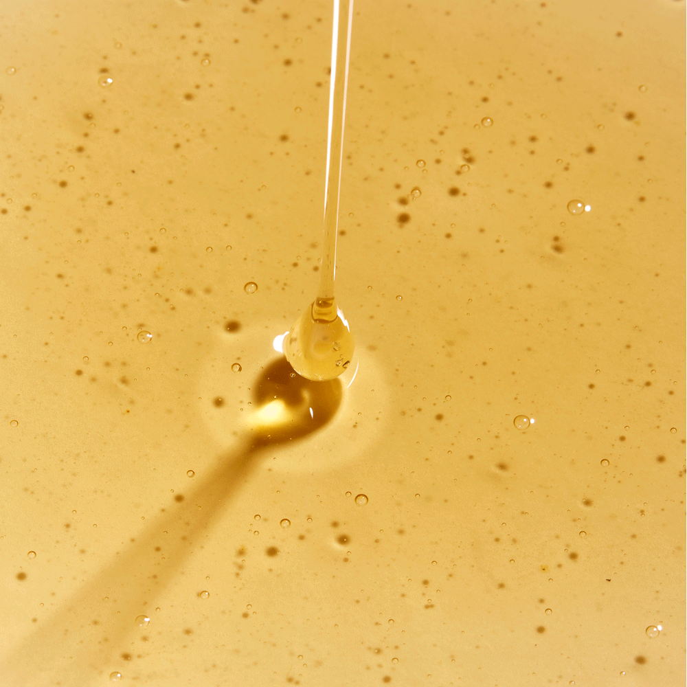 gif of rahua classic shampoo being poured out onto a puddle of classic shampoo on a flat surface to show texture of product shampoo is golden and somewhat thick|variant:2-oz